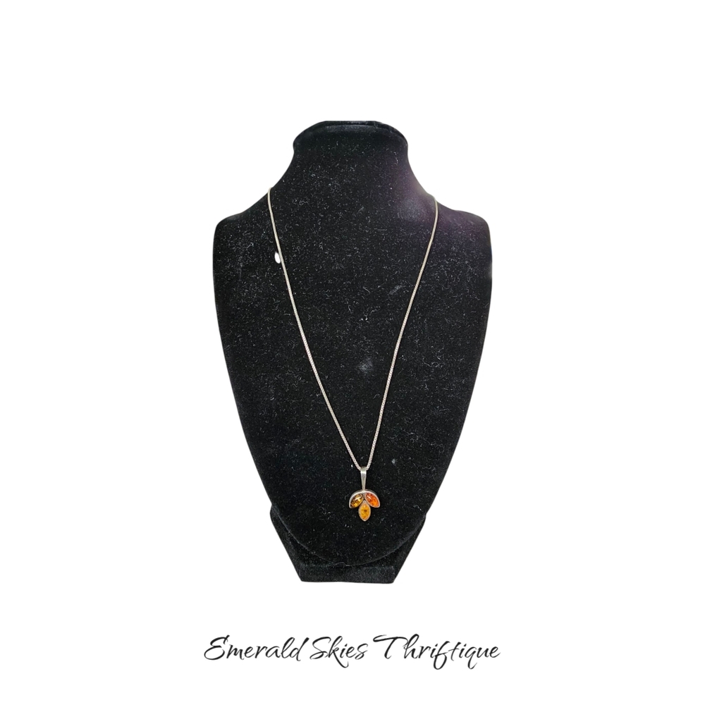 Sterling silver necklace with amber pendant.